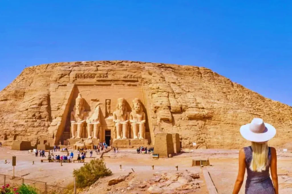 a-woman-with-long-blonde-hair-admires-the-abu-simbel-temple-aswan-egypt